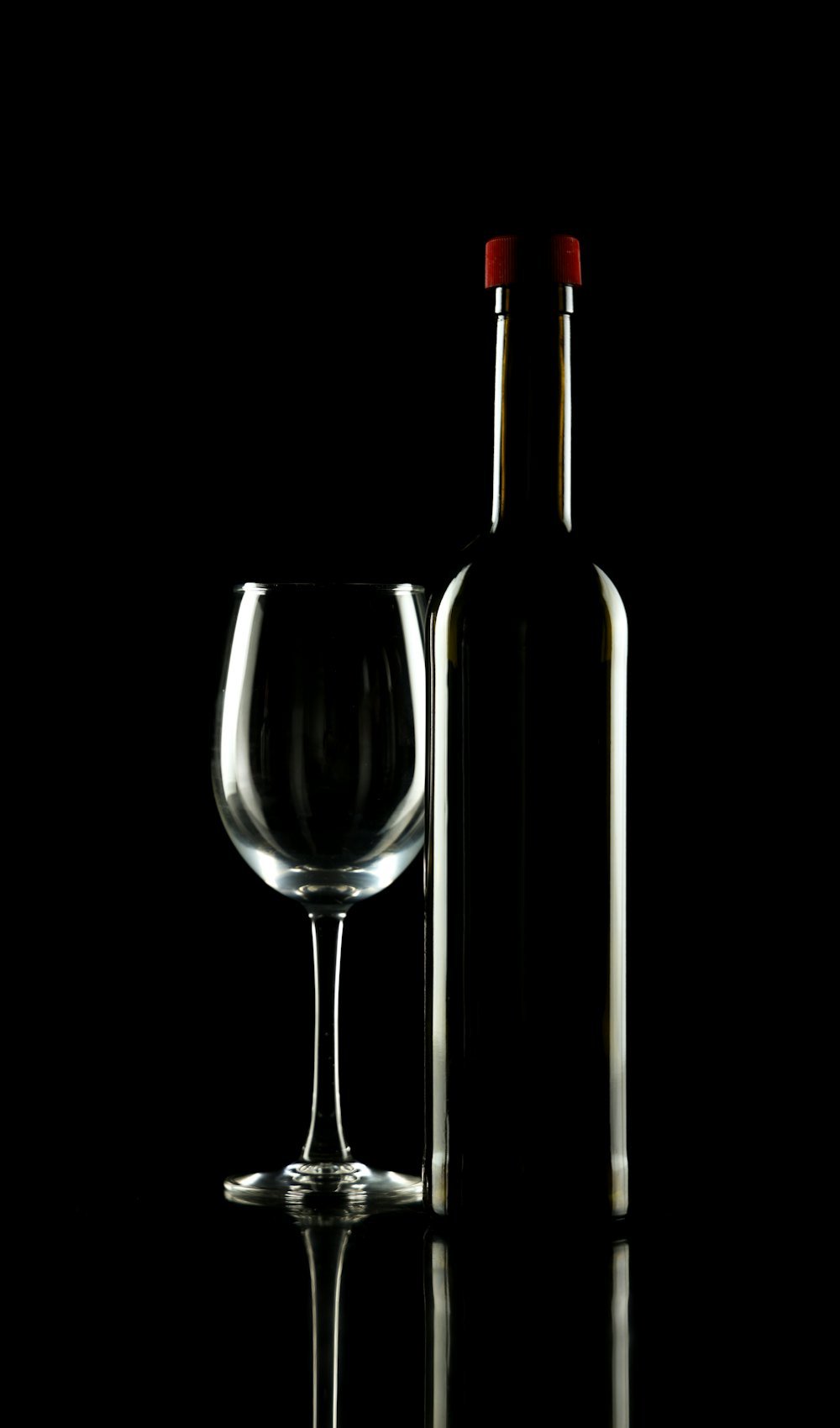 Bouteille de Chablis Premier Cru Vaucoupin et son verre, dans la pénombre
